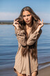 © Andrey_Arkusha - Portrait of a young brunette woman posing in beige tunic