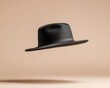 © Creator88 - Simple black floppy hat, flying gracefully, isolated on a neutral backdrop for a minimalist, chic look