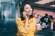© BullRun - Young Asian woman calling by smartphone