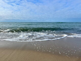 Wall Mural - blue seascape, sandy shoreline, white clouds at the sky, seashore