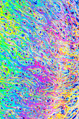 Wall Mural - Real photograph of a colorful light interference on a soap bubble surface with random swirls, curves and lines