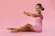 © New Africa - Portrait of little ballerina on pink background