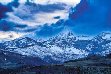 Sticker - 2023-12-31 MOODY SNOW COVERED ABSAROKA MOUNTAIN RANGE IN MONTANA WITH THE LOWER RANGES EXPOSED AND A CLOUDY SKY