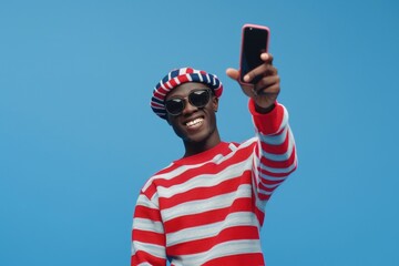 Poster - A man posing for a selfie while wearing a bold red and white striped shirt