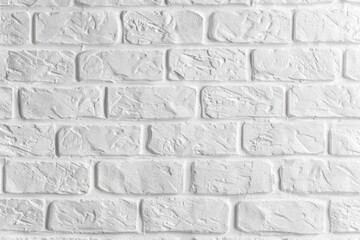 Poster - a close-up view of a white brick wall with small cracks and imperfections