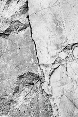 Poster - A black and white photo of a rock face with intricate patterns and textures