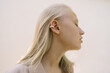 © Vradiy Art/Stocksy - Young blonde woman with earrings