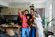 © BONNINSTUDIO/Stocksy - Happy family posing taking selfie in kitchen at home
