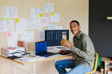 Developer working from home and smiling at camera
