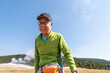 © Christine La/Stocksy - Portrait happy senior man yellowstone national park