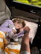 © Raymond Forbes LLC/Stocksy - UGC girl sleeping in back of car holding fathers hand
