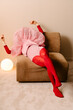 © Ulas&Merve/Stocksy - Fashionable Woman Relaxing in Red and Pink Ensemble