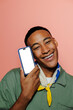 © BONNINSTUDIO/Stocksy - Man smiling and showing smartphone with blank screen