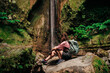 © Lucas Ottone/Stocksy - Femal hiker watching a waterfall