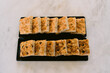 © Adrian Cotiga/Stocksy - Loaf style focaccia bread served on black trays