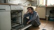 © Tekin - Upset Man Sitting In Front Of Damaged Dishwasher