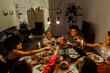 © BONNINSTUDIO/Stocksy - Cheerful family toasting during christmas dinner at home