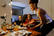 © BONNINSTUDIO/Stocksy - Happy family celebrating christmas eve at home