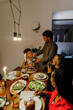 © BONNINSTUDIO/Stocksy - Happy family having Christmas dinner together at home