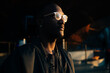 © Yakov Knyazev/Stocksy - Man with glasses illuminated by warm light in a dark environment