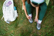 © DZ FILM/Stocksy - A woman ties her shoelaces in the woods