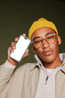 © BONNINSTUDIO/Stocksy - Stylish man showing smartphone with empty screen
