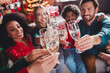 © deagreez - Photo of nice young people celebrate drink champagne enjoy cozy christmas decoration interior house indoors party