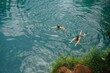 © Satya Gautam/Stocksy - Two People Swimming in Blue Lagoon