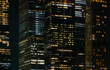 Illuminated New York skyscrapers at night with glowing office windows