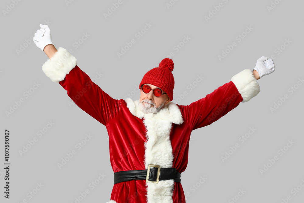 Cool Santa Claus in sunglasses on grey background