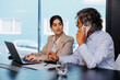 © BONNINSTUDIO/Stocksy - Business people working together in modern office using laptop
