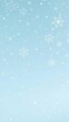© Kingphet - Snowflakes falling gently on a plain blue background, creating a serene winter scene, January, minimalist