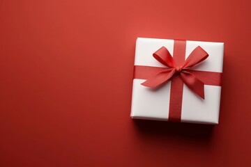 Wall Mural - A white box with a red bow on top of a red background