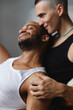 © Michela Ravasio/Stocksy - Happy gay couple embracing and smiling together