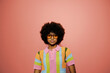 © BONNINSTUDIO/Stocksy - Woman wearing colorful clothes and sunglasses in studio