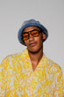 © BONNINSTUDIO/Stocksy - Fashion model posing wearing sunglasses and bucket hat