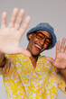 © BONNINSTUDIO/Stocksy - Cheerful man wearing sunglasses and bucket hat in studio