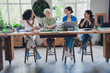 © deagreez - Full length photo of lovely four businessladies feminist meeting discuss project community comfortable startup meeting office room interior