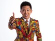 © niti - Asian man in an abstractpatterned suit, pointing at the camera, white background