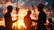 © kongkiat chairat - Civil engineers collaborating at sunset on construction site, showcasing teamwork and technology. silhouettes against vibrant sky highlight their dedication