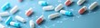 © My Stock 4 U - Colorful capsules scattered on a blue background, intersected by digital lines, suggesting a connection to healthcare or pharmaceuticals.