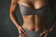 © smth.design - Athletic Woman in Gray Activewear Displaying Fit Body Against Dark Background