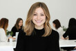 © smth.design - Professional woman smiling in modern collaborative office environment