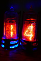 Poster - Retro Nixie lamp indicator clock on dark background. The Nixie tube indicator of the numbers of retro style.