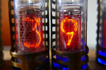 Poster - Retro Nixie lamp indicator clock on dark background. The Nixie tube indicator of the numbers of retro style.