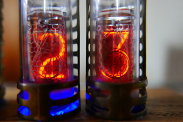 Poster - Retro Nixie lamp indicator clock on dark background. The Nixie tube indicator of the numbers of retro style.