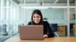 © velikiyzayats - Smiling Businesswoman Using Laptop in Modern Office Setting, Ideal for Business Marketing or Website Design