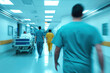 © photobuay - Blurred hospital scene with healthcare professionals walking in scrubs. atmosphere conveys urgency and care in medical environment