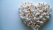 © Eugenia - A playful display of popcorn forms a heart shape, perfect for celebrating love or a movie night. Ideal for gatherings or special occasions