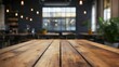 © Lilly - Empty wooden table in a cafe with a blurred background.